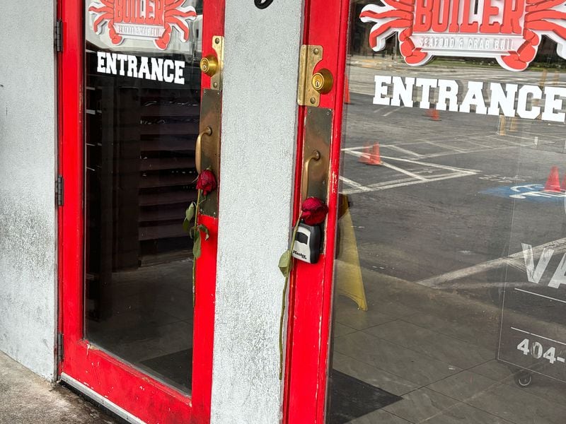 Roses were placed through the front door handles at Chad Dillon's restaurant, the Boiler Seafood. 