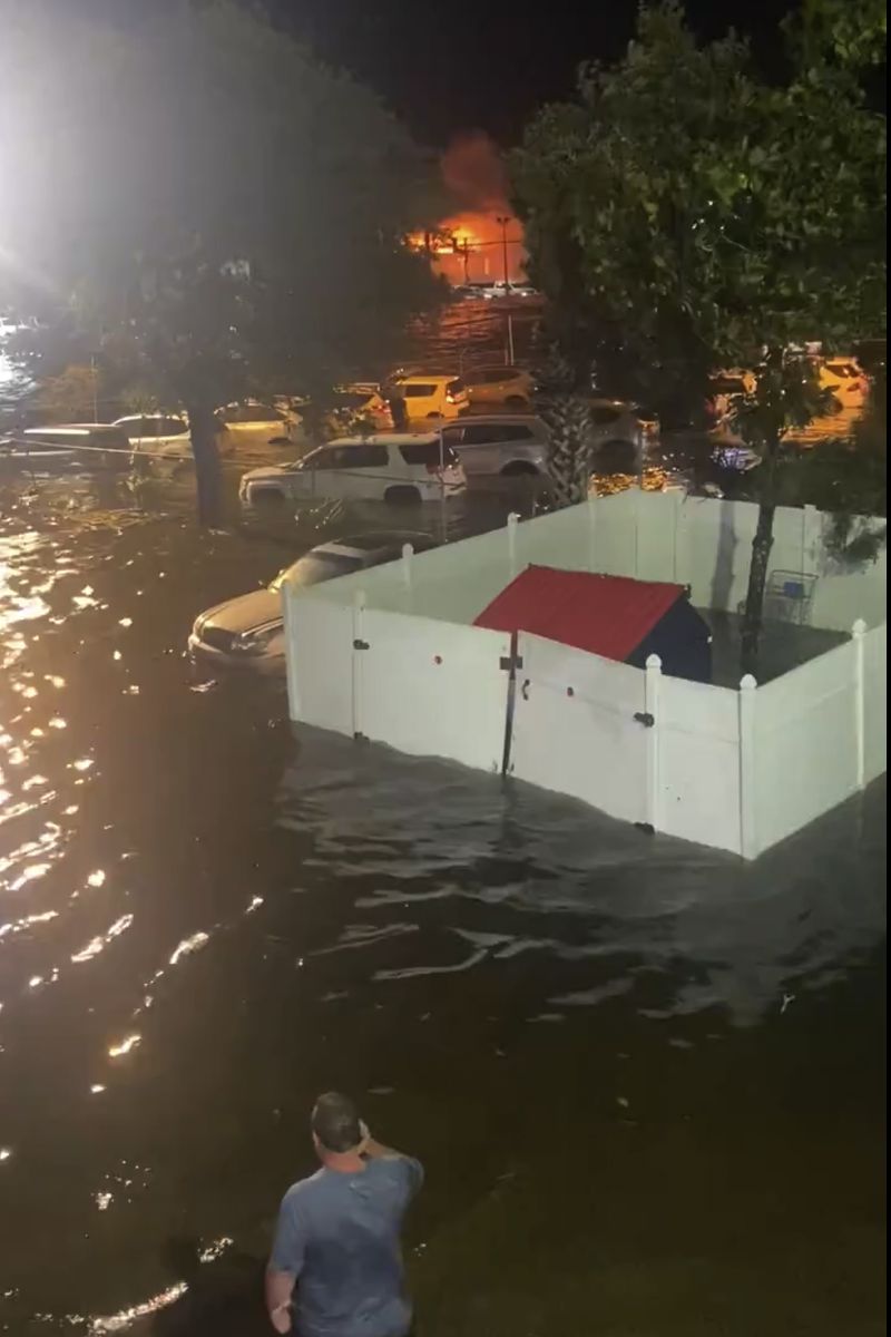 A person looks over a flooded street due to Hurricane Helene late Thursday, Sept. 26, 2024 in New Port Richey, Fla. (Danielle Molisee via AP)