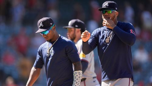 Atlanta Braves' Ronald Acuna Jr., right, and Ozzie Albies, left, walk off the field after a baseball game against the Los Angeles Angels, Sunday, Aug. 18, 2024, in Anaheim, Calif. (AP Photo/Ryan Sun)