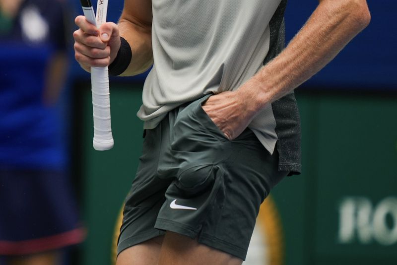 FILE - Jannik Sinner, of Italy, reaches for a ball in his pocket before serving to Alex Michelsen, of the United States, during the second round of the U.S. Open tennis championships, Aug. 29, 2024, in New York. (AP Photo/Julia Nikhinson, File)