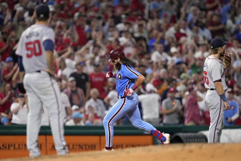 Philadelphia Phillies' Brandon Marsh, center, rounds the bases after hitting a three-run home run against Atlanta Braves pitcher Charlie Morton during the sixth inning of a baseball game, Thursday, Aug. 29, 2024, in Philadelphia. (AP Photo/Matt Slocum)