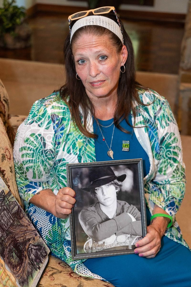 Dawn Mclendon holds a photo of her late her son Travis.  PHIL SKINNER FOR THE ATLANTA JOURNAL-CONSTITUTION