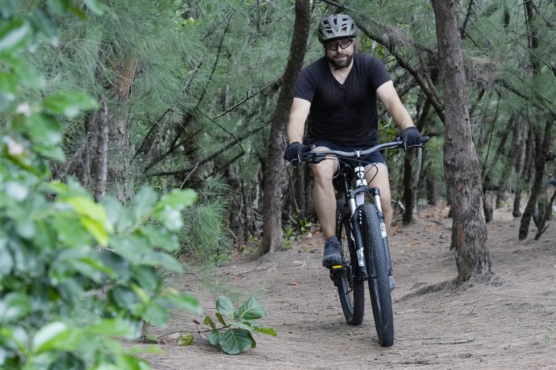 Javier Fernandez, of Hollywood, rides on a mountain bike trail at Oleta River State Park, Thursday, Aug. 22, 2024, in North Miami Beach, Fla. (AP Photo/Marta Lavandier)