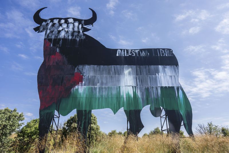 A Spanish fighting bull billboard, is painted with the colours of the Palestinian flag and a writing that reads "free Palestine", on the outskirts of Madrid, Tuesday, May 28, 2024. Spain and Norway have moved to formally recognize a Palestinian state with Ireland to follow suit on Tuesday in a coordinated effort by the three western European nations. While dozens of countries have recognized a Palestinian state, none of the major Western powers has done so. (AP Photo/Bernat Armangue)