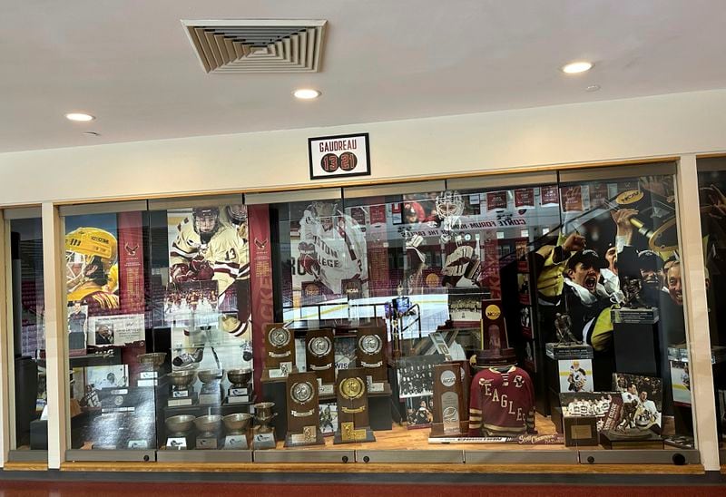 A sign hangs above the trophy case at Boston College's Conte Forum mourning the deaths of former Eagles hockey players Johnny and Matthew Gaudreau in Boston, Wednesday, Sept. 4, 2024. (AP Photo/Jimmy Golen)