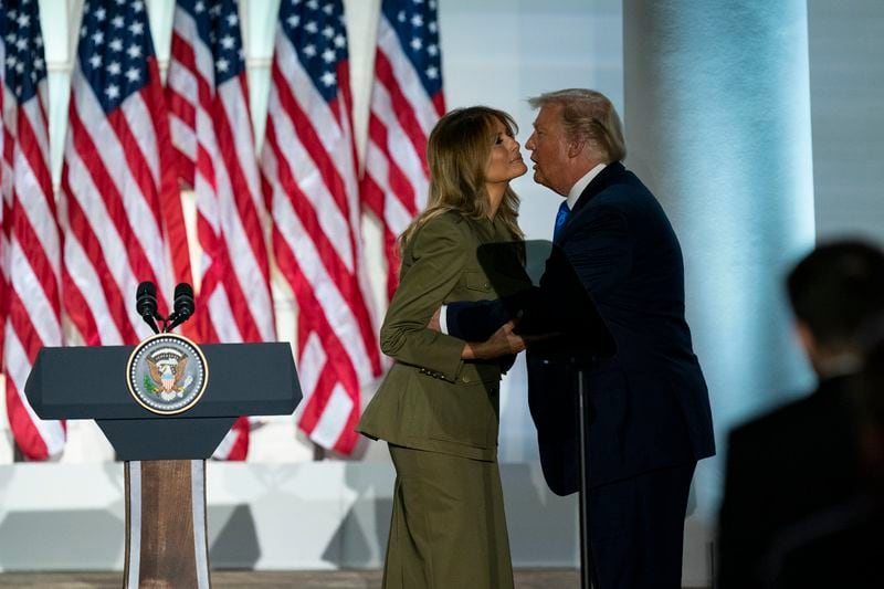 FILE - President Donald Trump joins first lady Melania Trump on stage after her speech to the 2020 Republican National Convention from the Rose Garden of the White House, Aug. 25, 2020, in Washington. (AP Photo/Evan Vucci, File)