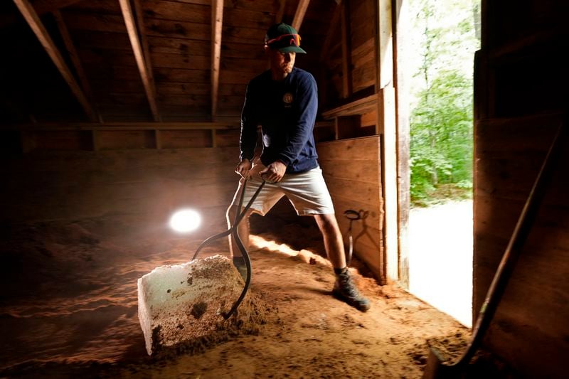 Nate Lord hauls out a block of ice at Rockywold Deephaven Camps, Thursday, June 20, 2024, in Holderness, N.H. Ice harvested from Squam Lake during the winter is insulated with sawdust in an ice house. It is used for refrigeration in ice boxes at each guest cabin throughout the summer. (AP Photo/Robert F. Bukaty)
