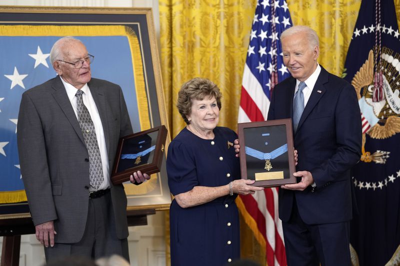 President Joe Biden presents the Medal of Honor to Theresa Chandler, the great great granddaughter of Pvt. George D. Wilson in the East Room at the White House in Washington, Wednesday, July 3, 2024. The medals posthumously honor two U.S. Army privates who were part of a daring Union Army contingent that stole a Confederate train during the Civil War. U.S. Army Pvts. Philip G. Shadrach and George D. Wilson were captured by Confederates and executed by hanging. At left is Gerald Taylor, the great great nephew of Pvt. Philip G. Shadrach. (AP Photo/Susan Walsh)