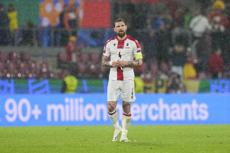 Georgia's Guram Kashia walks off the pitch after a round of sixteen match between Spain and Georgia at the Euro 2024 soccer tournament in Cologne, Germany, Sunday, June 30, 2024. (AP Photo/Martin Meissner)