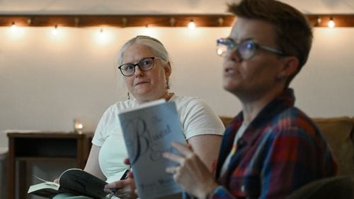 Candace Rowell (right), organizer, and Jessica Perlove discuss "The Bluest Eye" by Toni Morrison this month with other participants, who have joined online, at a banned book club meeting at Virginia-Highland Church, Thursday, September 19, 2024, in Atlanta. (Hyosub Shin / AJC)