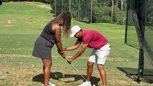 Morehouse golf coach Edgar Evans, a PGA professional, gave quick lessons on the practice tee. Here he's working with Courtney Johnson at Eastside Golf's Community Golf Day, Aug. 3, 2024. (Photo by Stan Awtrey)