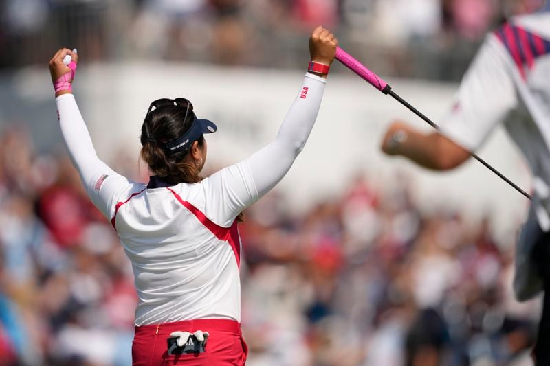 United States' Lilia Vu celebrates after making a putt on the 18th green to give the United States the win over Europe during the Solheim Cup golf tournament at the Robert Trent Jones Golf Club, Sunday, Sept. 15, 2024, in Gainesville, Va. (AP Photo/Matt York)