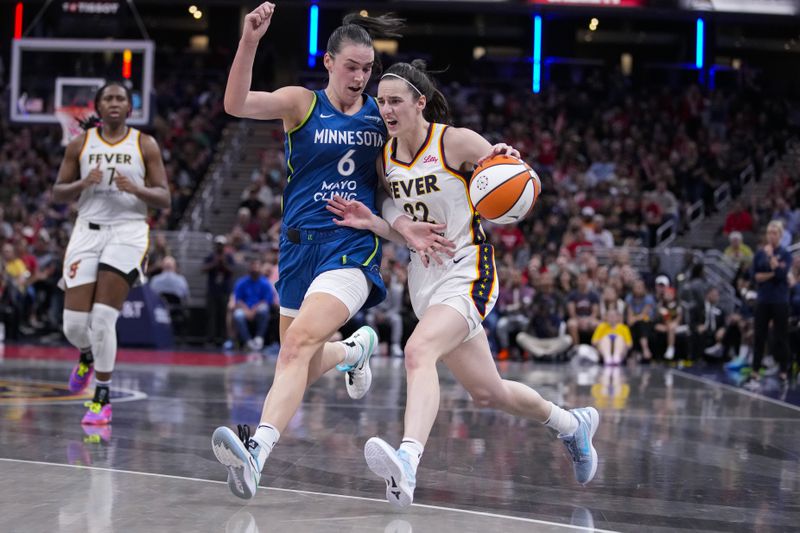 Indiana Fever guard Caitlin Clark (22) goes up against Minnesota Lynx forward Bridget Carleton (6) during the second half of a WNBA basketball game in Indianapolis, Friday, Sept. 6, 2024. (AP Photo/Michael Conroy)