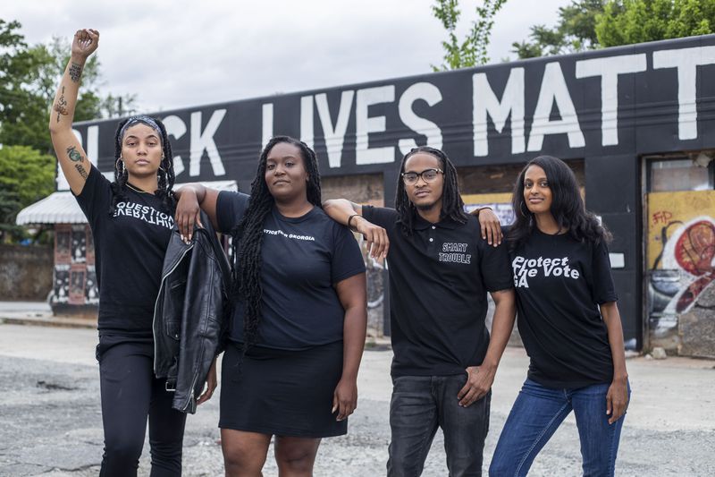 05/11/2021 — Atlanta, Georgia — Activists Qri Montague, from left, Britt Jones-Chukura, Scotty Smart and Hannah Joy Gebresilassie pose for a portrait in Atlanta’s Cabbagetown community, Tuesday, May 11, 2021. These activists are collectively fighting for Black Lives through their various organizations. (Alyssa Pointer / Alyssa.Pointer@ajc.com)