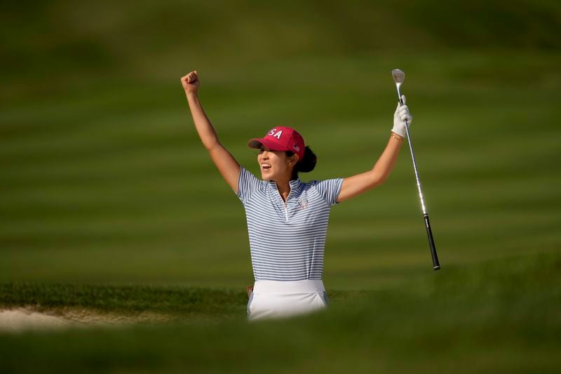 United States' Rose Zhang celebrates after hitting out of a bunker and into the cup on the 13th hole during a Solheim Cup golf tournament fourball match at Robert Trent Jones Golf Club, Saturday, Sept. 14, 2024, in Gainesville, Va. (AP Photo/Matt York)