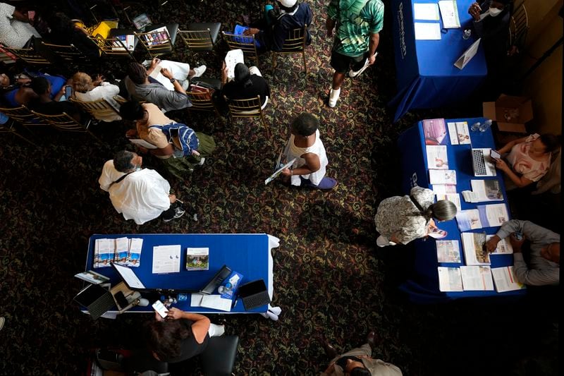 People walk past displays at the Black Health Matters Health Summit and Expo in New York, Thursday, Aug. 15, 2024. (AP Photo/Pamela Smith)