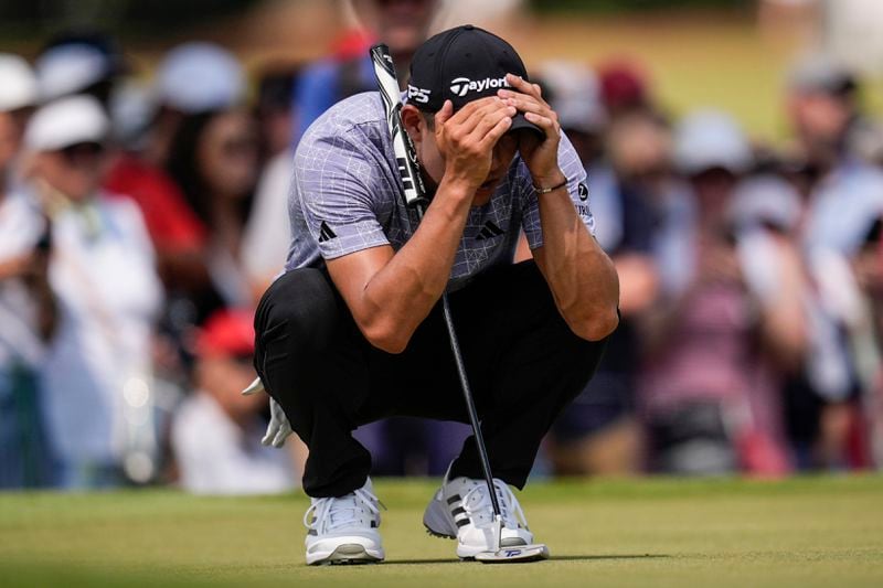 Collin Morikawa lines up a putt on the fifth green during the second round of the Tour Championship golf tournament, Friday, Aug. 30, 2024, in Atlanta. (AP Photo/Mike Stewart)