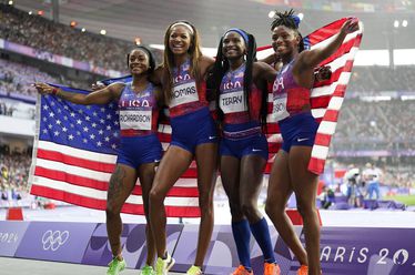 Sha'carri Richardson,Gabrielle Thomas, Twanisha Terry, and Melissa Jefferson, of the United States, pose after winning the gold medal in the women's 4 x 100 meters relay final at the 2024 Summer Olympics, Friday, Aug. 9, 2024, in Saint-Denis, France. (AP Photo/Ashley Landis)