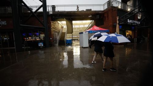 Concession workers walk inside Truist Park on Wednesday, September 25, 2024 after the Braves game was postponed due to weather. 
(Miguel Martinez/ AJC)