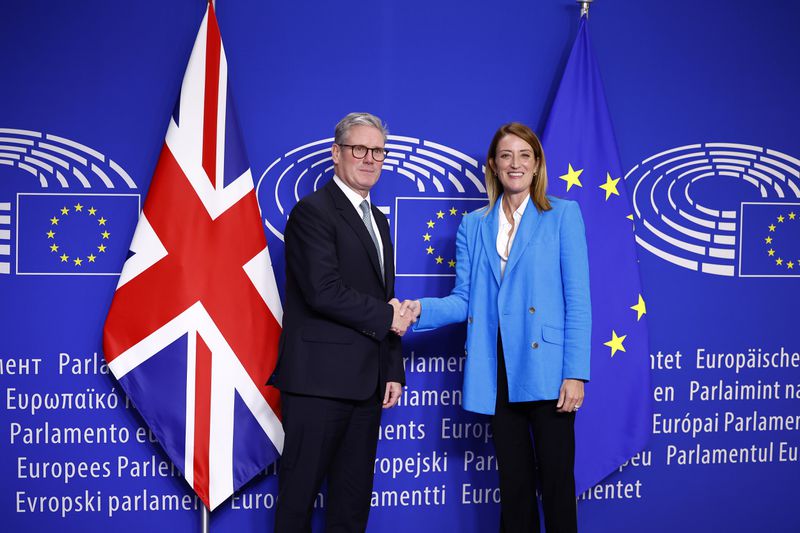 Britain's Prime Minister Keir Starmer, left, poses for a photograph with European Parliament President Roberta Metsola at the European Commission headquarters in Brussels, Wednesday, Oct. 2, 2024. (Benjamin Cremel/Pool Photo via AP)