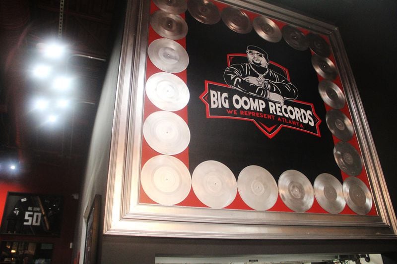 A large display of platinum records surrounds a logo of Big Oomp Records inside BOSK. (Mike Jordan/AJC)