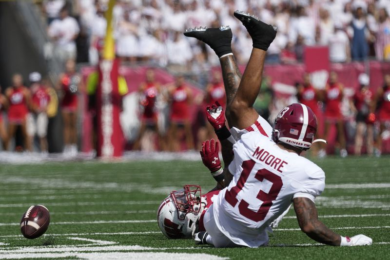 Wisconsin's Chez Mellusi (1) fumbles as he is hit by Alabama's Malachi Moore (13) during the first half of an NCAA college football game Saturday, Sept. 14, 2024, in Madison, Wis. (AP Photo/Morry Gash)