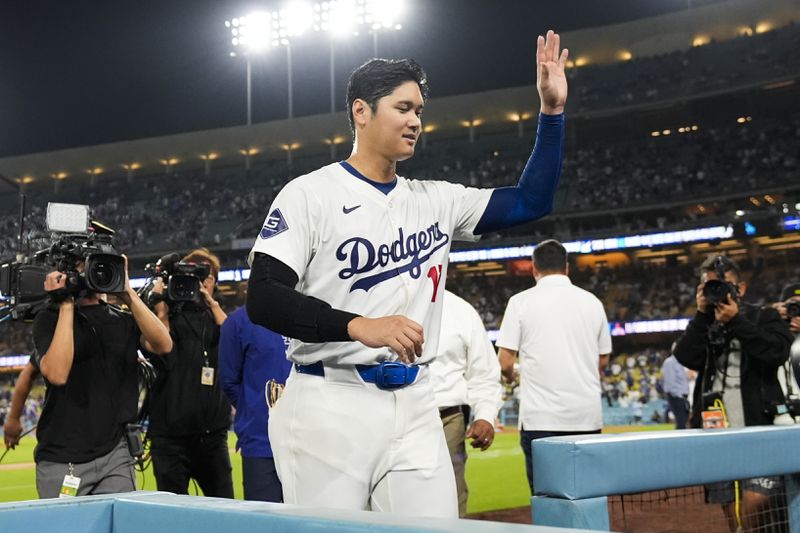 Los Angeles Dodgers designated hitter Shohei Ohtani (17) leaves the field after hitting a grand slam during the ninth inning of a baseball game against the Tampa Bay Rays in Los Angeles, Friday, Aug. 23, 2024. The Dodgers won 7-3. Will Smith, Tommy Edman, and Max Muncy also scored. (AP Photo/Ashley Landis)