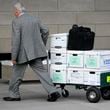 Case documents are wheeled into federal court Monday, June 17, 2024, in Los Angeles.  (AP Photo/Damian Dovarganes)