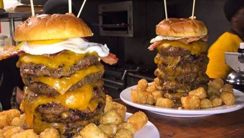 The John Henry Challenge at Local 7 in Tucker includes seven burger patties with a fried egg and cheese, along with tater tots or fries. / Courtesy of Local 7