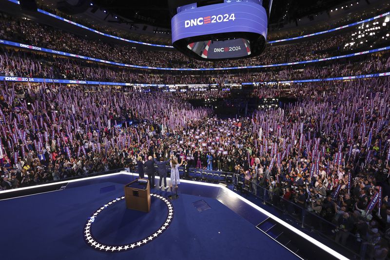 Democratic vice presidential nominee Minnesota Gov. Tim Walz is joined on stage by his wife Gwen, and children Gus and Hope, on the third day of the Democratic National Convention in Chicago, Wednesday, Aug. 21, 2024. (Mike Segar/Pool via AP)