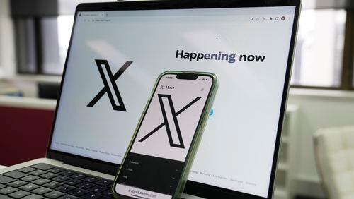 FILE - The opening page of X is displayed on a computer and phone in Sydney on Oct. 16, 2023. An Australian judge has ruled that the social media platform X is subject to a state’s anti-discrimination law even though it does not have an office in Australia. (AP Photo/Rick Rycroft, File)
