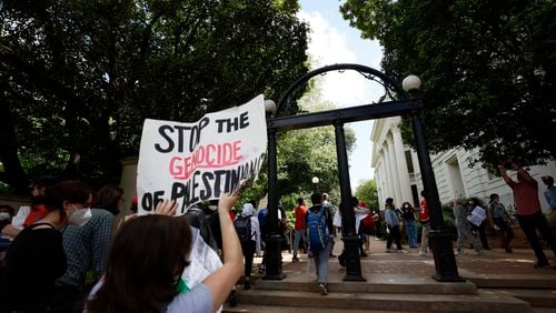 Dozens of Pro-Palestinian protesters chant as they cross the University Arch at UGA campus in Athens following arrests on Monday, April 29, 2024.
(Miguel Martinez / AJC)