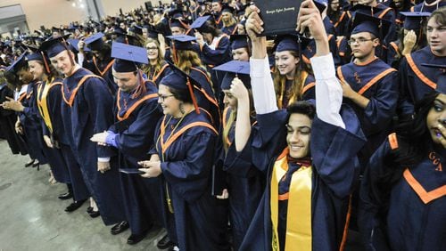 Elias Madera raises his diploma during the Georgia Cyber Academy commencement, Saturday, May 21, 2016, held at Cobb Galleria Centre in Atlanta.  (Photo/John Amis)