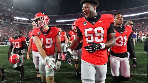 Georgia tight end Brock Bowers (19) and Georgia offensive lineman Bo Hughley (59) celebrate after Georgia beat Mississippi during an NCAA football game at Sanford Stadium, Saturday, November 11, 2023, in Athens. Georgia won 52-17 over Mississippi. (Hyosub Shin / Hyosub.Shin@ajc.com)