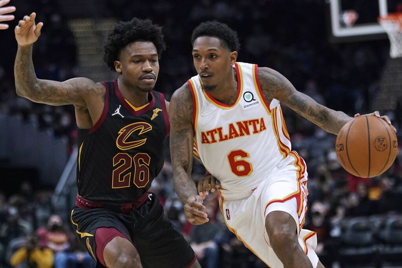 Atlanta Hawks' Lou Williams (6) drives against Cleveland Cavaliers' Brandon Goodwin (26) during the second half of an NBA basketball game Friday, Dec. 31, 2021, in Cleveland. Atlanta won 121-118. (AP Photo/Tony Dejak)