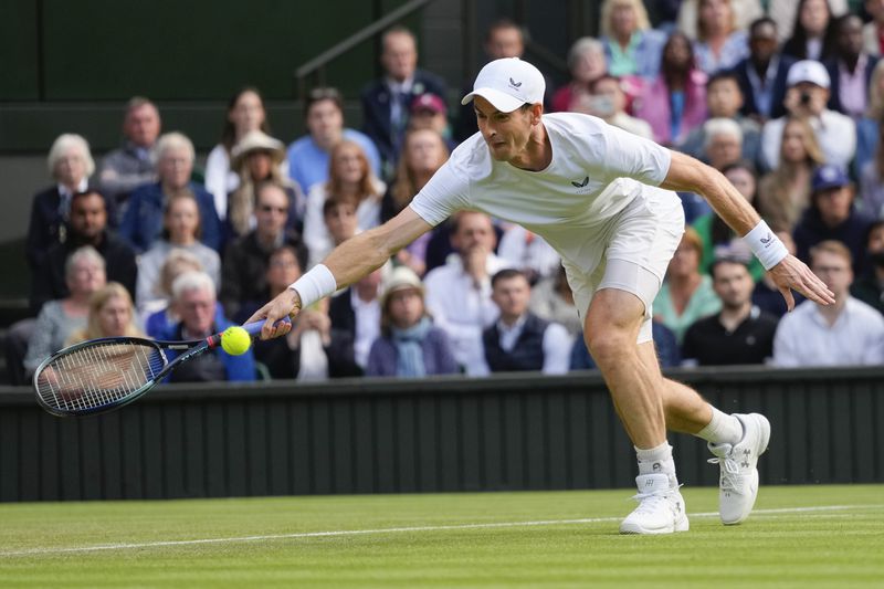 Britain's Andy Murray and his brother Jamie in action during their first round doubles match against Australia's John Peers and Ricky Hijikata at the Wimbledon tennis championships in London, Thursday, July 4, 2024. (AP Photo/Kirsty Wigglesworth)