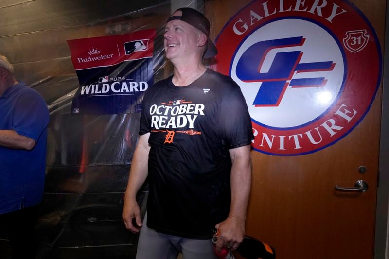 Detroit Tigers manager A.J. Hinch celebrates with his team in the clubhouse after defeating the Houston Astros in Game 2 to clinch the AL Wild Card baseball series, Wednesday, Oct. 2, 2024, in Houston. (AP Photo/Kevin M. Cox)