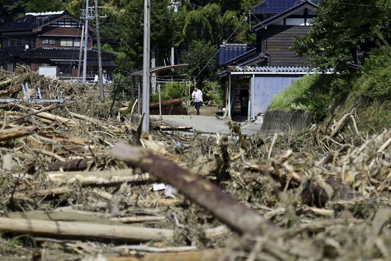 Debris and driftwoods cover rice fields in Suzu, Japan, Monday, Sept. 23, 2024, following heavy rain in central Japan's Noto peninsula area, where a devastating earthquake took place on Jan. 1. (Tsuyoshi Ueda/Kyodo News via AP)