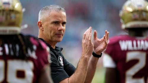 FILE - Florida State head coach Mike Norvell claps as his players warm up for the Orange Bowl NCAA college football game against Georgia, Saturday, Dec. 30, 2023, in Miami Gardens, Fla. (AP Photo/Rebecca Blackwell, File)