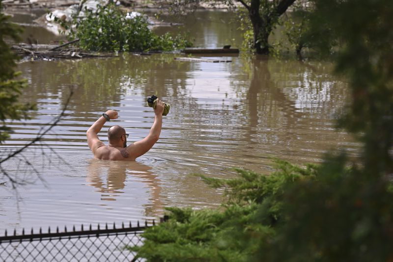 A man wades through flood water in Opava, Czech Republic, Sunday Sept. 15, 2024. (Jaroslav Ozana/CTK via AP)