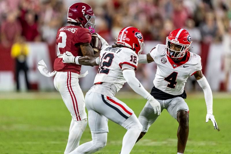 Alabama wide receiver Ryan Williams (2) grabs a pass and turns to run to the end zone for a 75-yard touchdown during the second half of an NCAA college football game against Georgia, Saturday, Sept. 28, 2024, in Tuscaloosa, Ala. Defending the play are Georgia defensive backs Julian Humphrey (12) and KJ Bolden (4). (AP Photo/Vasha Hunt)