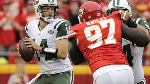 New York Jets quarterback Ryan Fitzpatrick (14) prepares to throw as center Nick Mangold, right, blocks Kansas City Chiefs defensive lineman Allen Bailey (97) during the first half of an NFL football game in Kansas City, Mo., Sunday, Sept. 25, 2016. (AP Photo/Charlie Riedel)