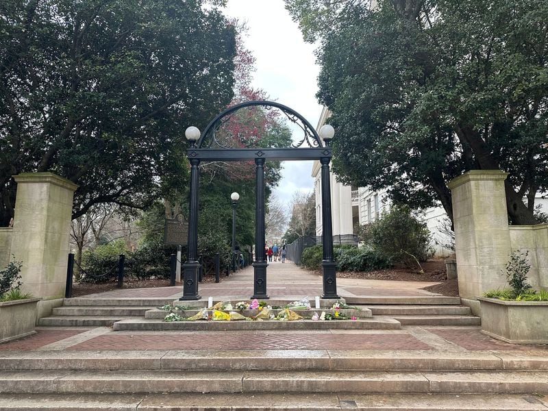 Flowers were left at the Arch at the University of Georgia after Laken Riley, a 22-year-old nursing student, was found dead on the campus last month. A man authorities say entered the country illegally in 2022 has been charged with murder in her death. (Fletcher Page/The Atlanta Journal-Constitution/TNS)