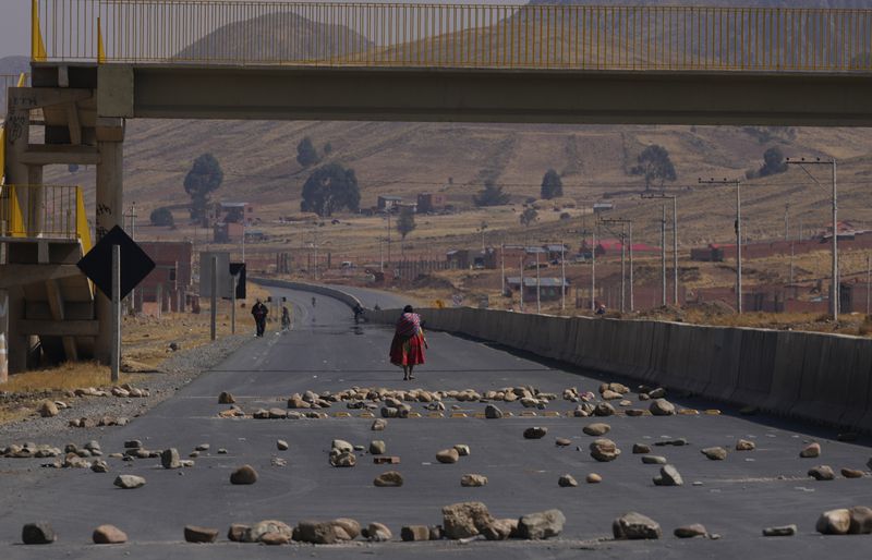 Rocks block a highway towards Lake Titicaca in Vilaque on the outskirts of El Alto, Bolivia, Monday, Sept. 16, 2024. The rocks were placed by people protesting for the resignation of Bolivian President Luis Arce for his management of the economy. (AP Photo/Juan Karita)