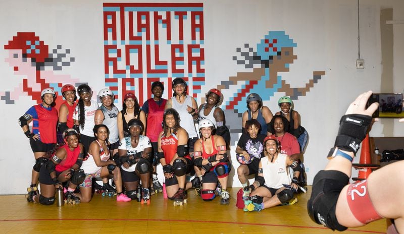 Black players take a group photo at the Atlanta Roller Derby practice facility in Mableton on Wednesday, May 22, 2024. (Arvin Temkar / AJC)