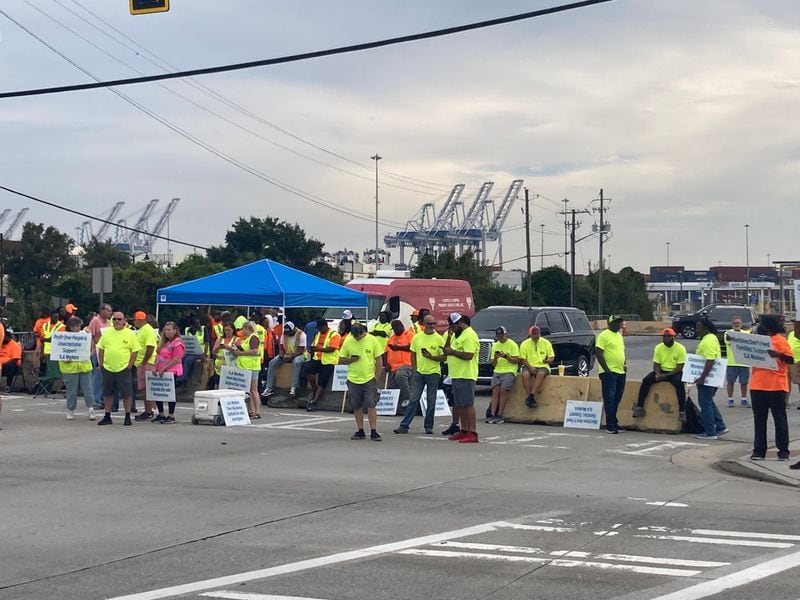 Union dockworkers picket at the main gate at the Georgia Ports Authority's Garden City Terminal on Tuesday as part of the International Longshoremen's Association strike, (Adam Van Brimmer/AJC)