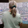 Dunwoody resident Mimi Deupree looks at maps during an open house in Dunwoody hosted by the Georgia Department of Transportation to provide info on toll lanes proposed for the top end of I-285. (Natrice Miller/ AJC)