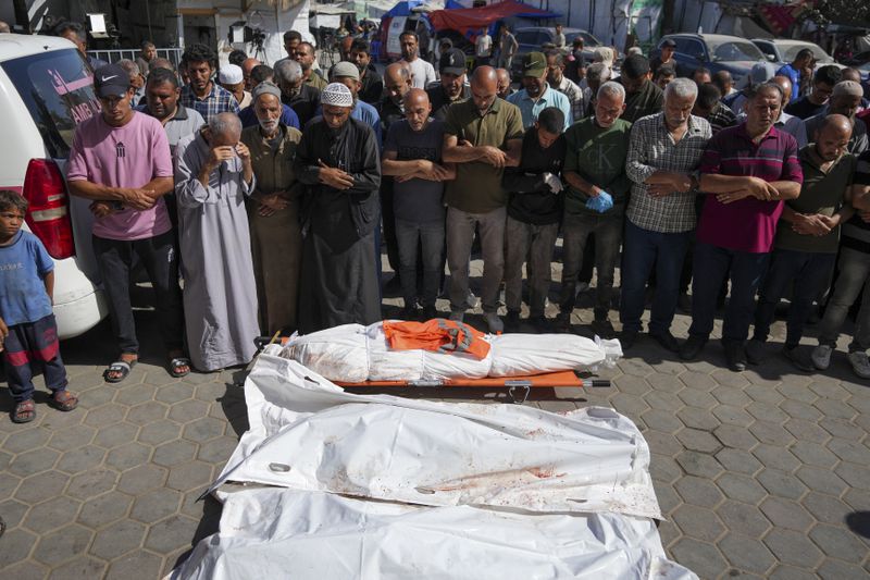 Palestinians pray for people killed in the Israeli bombardment of the Gaza Strip at a hospital in Deir al Balah on Friday, June 7, 2024. (AP Photo/Abdel Kareem Hana)