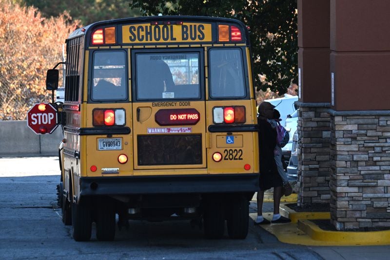 Gwinnett school bus makes a stop on Tuesday, November 7, 2023, in Duluth. (Hyosub Shin / Hyosub.Shin@ajc.com)