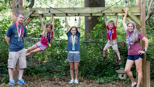 (L-R) Dad John; Libby, 9; Abby, 12; James, 5; and mom Ashley Coleman pose for a portrait at their home in Decatur on Thursday, May 23, 2024. The family is on a quest to run a race in every county in Georgia. (Arvin Temkar / AJC)